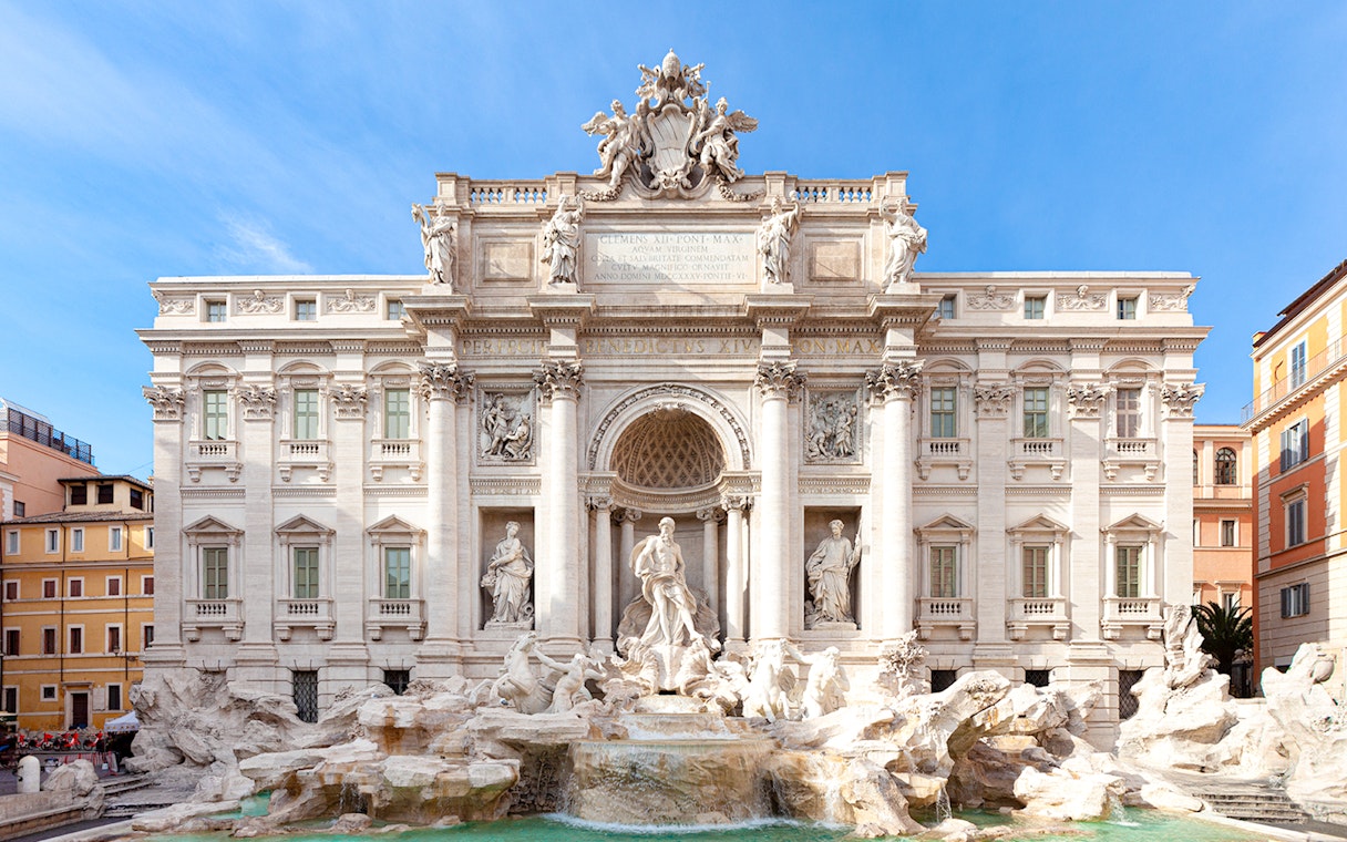 Trevi Fountain in Rome with ornate sculptures and flowing water.