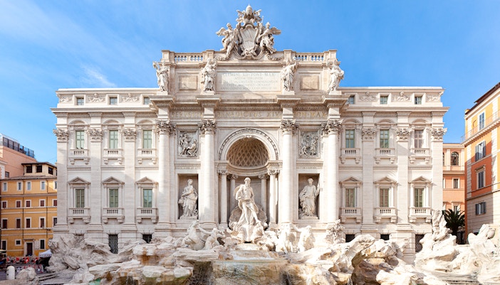 Trevi Fountain in Rome with ornate sculptures and flowing water.
