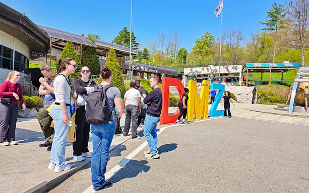 People gathered at the DMZ sign during a Seoul to DMZ tour in South Korea.