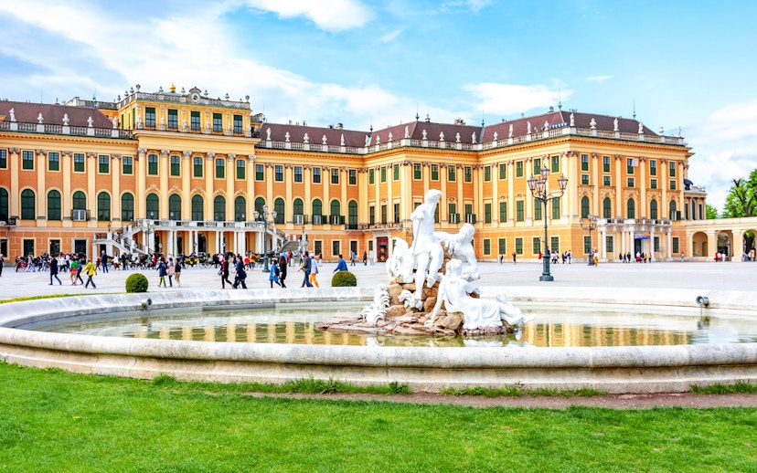 Fountain at Schönbrunn Palace Gardens with palace in the background, Vienna.