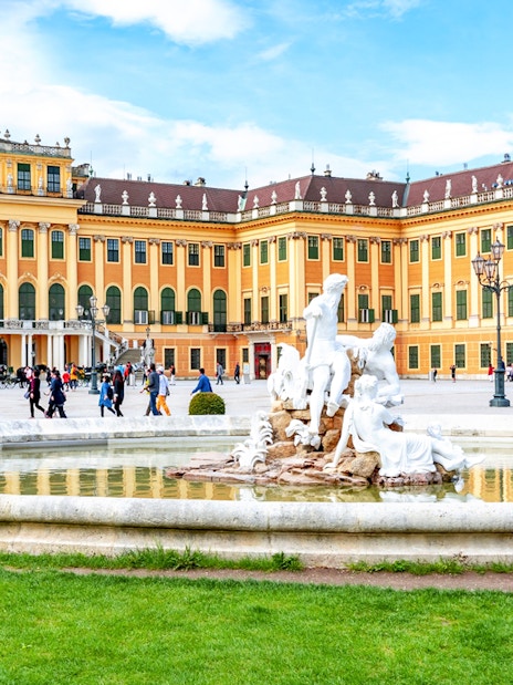 Fountain at Schönbrunn Palace Gardens with palace in the background, Vienna.