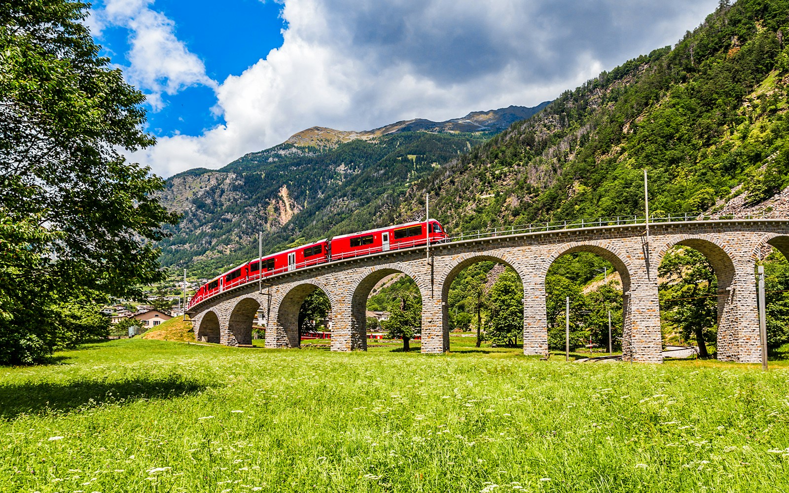 Scenic view from the Bernina Express train tour in Switzerland, showcasing the breathtaking alpine landscape of Brusio Circular Viadcut.