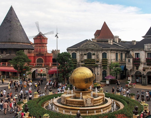 Central square in Ba Na Hills with globe fountain and European-style buildings.