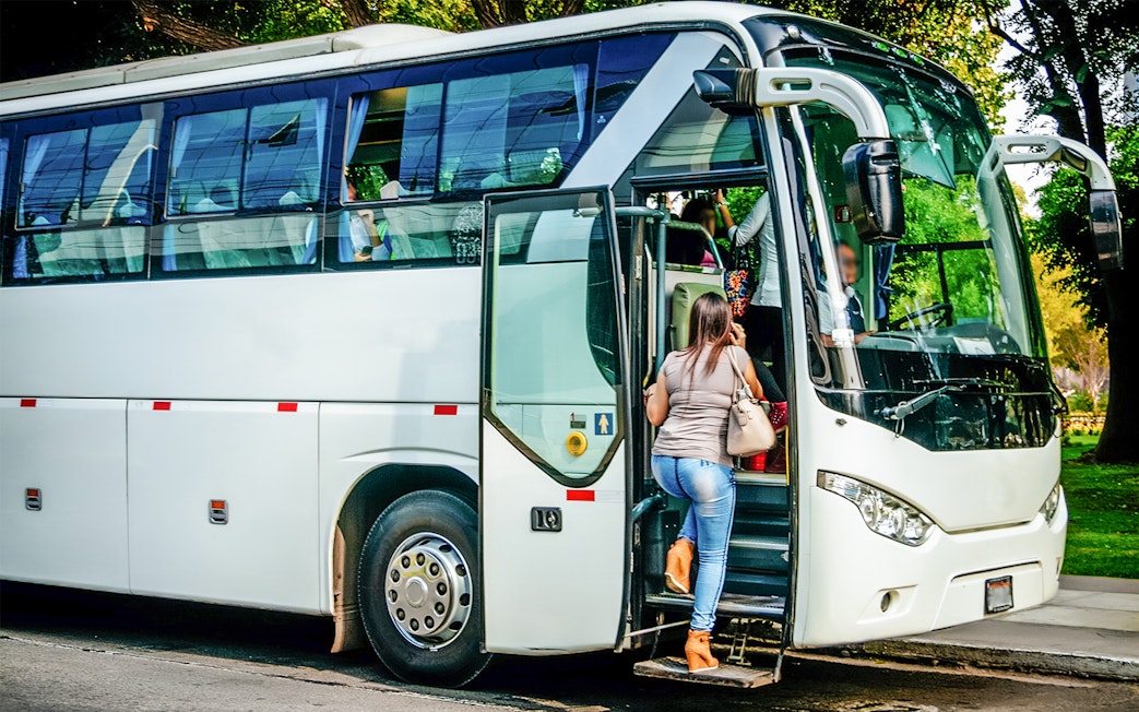 Passenger boarding the Amsterdam Airport Express bus.