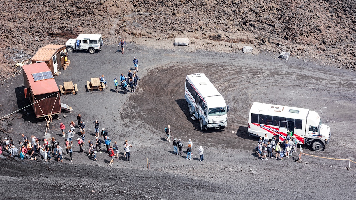 Tourists disembarking from a 4x4 vehicle on a guided tour at Mount Etna, Sicily.