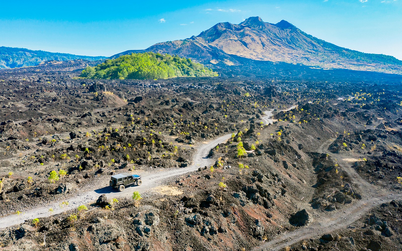 Off road vehicle fording solidified lava flows - Mount Batur