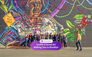 Brooklyn street art mural with a group of tourists on a walking tour.