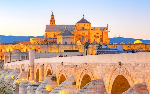 Mezquita de Córdoba and Roman Bridge at sunset, Córdoba, Spain.