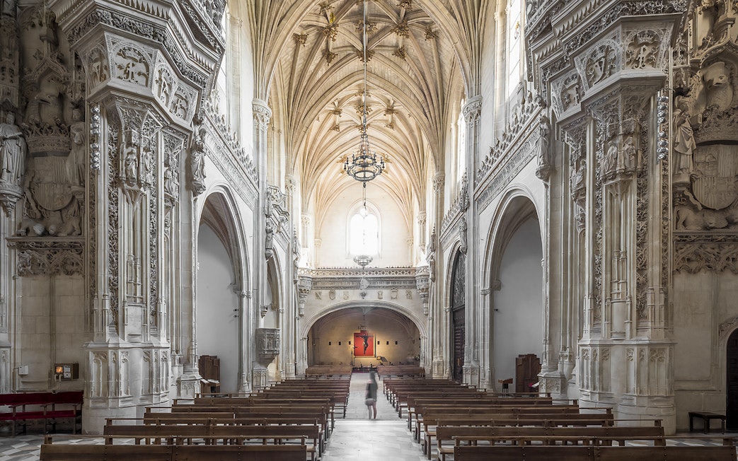 Interior of Monastery of San Juan de los Reyes, Toledo, with ornate Gothic architecture.