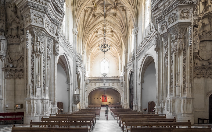 Interior of Monastery of San Juan de los Reyes, Toledo, with ornate Gothic architecture.