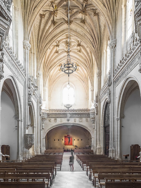 Interior of Monastery of San Juan de los Reyes, Toledo, with ornate Gothic architecture.