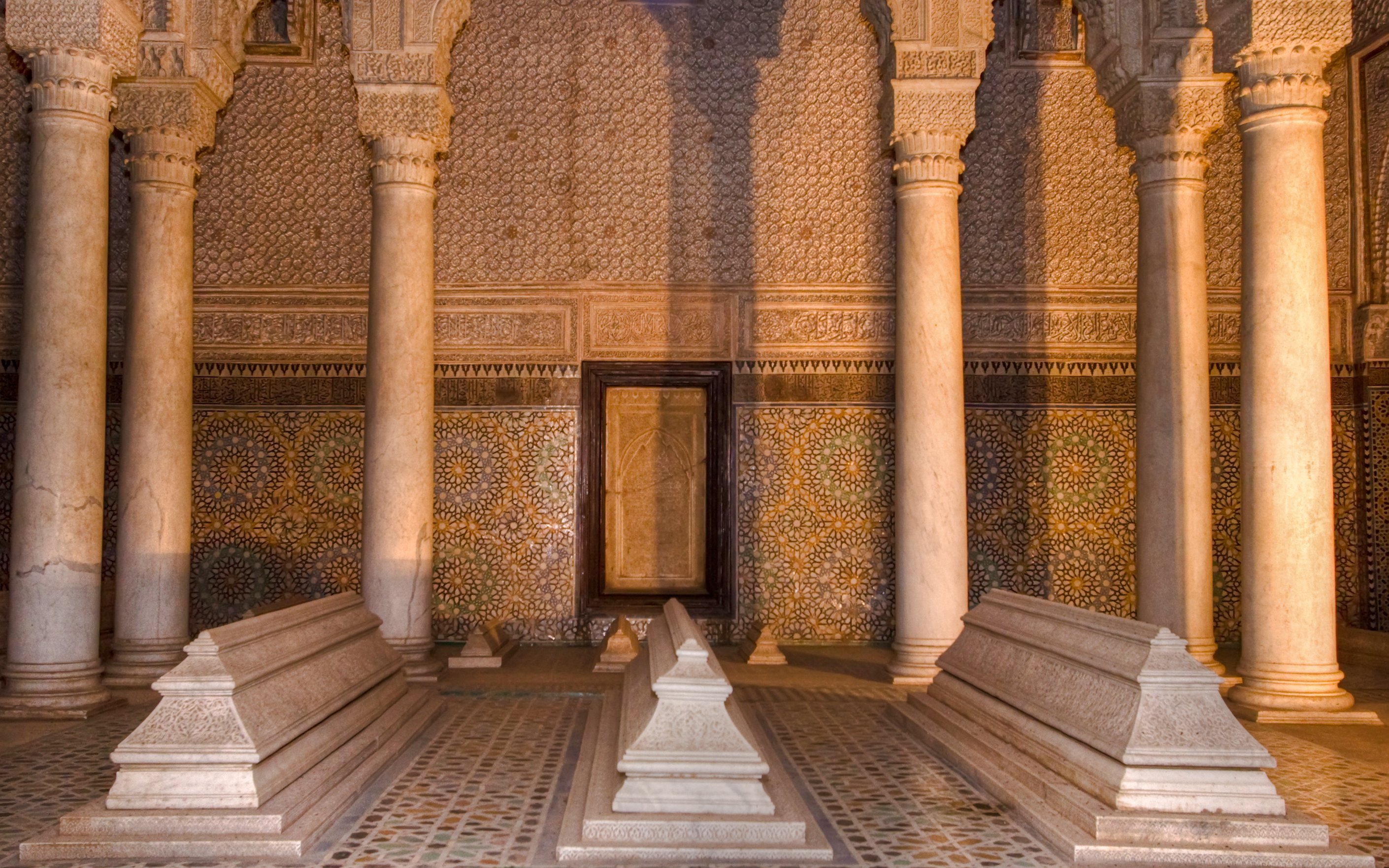 Saadian tombs with ornate columns and mosaic tiles in Marrakesh.