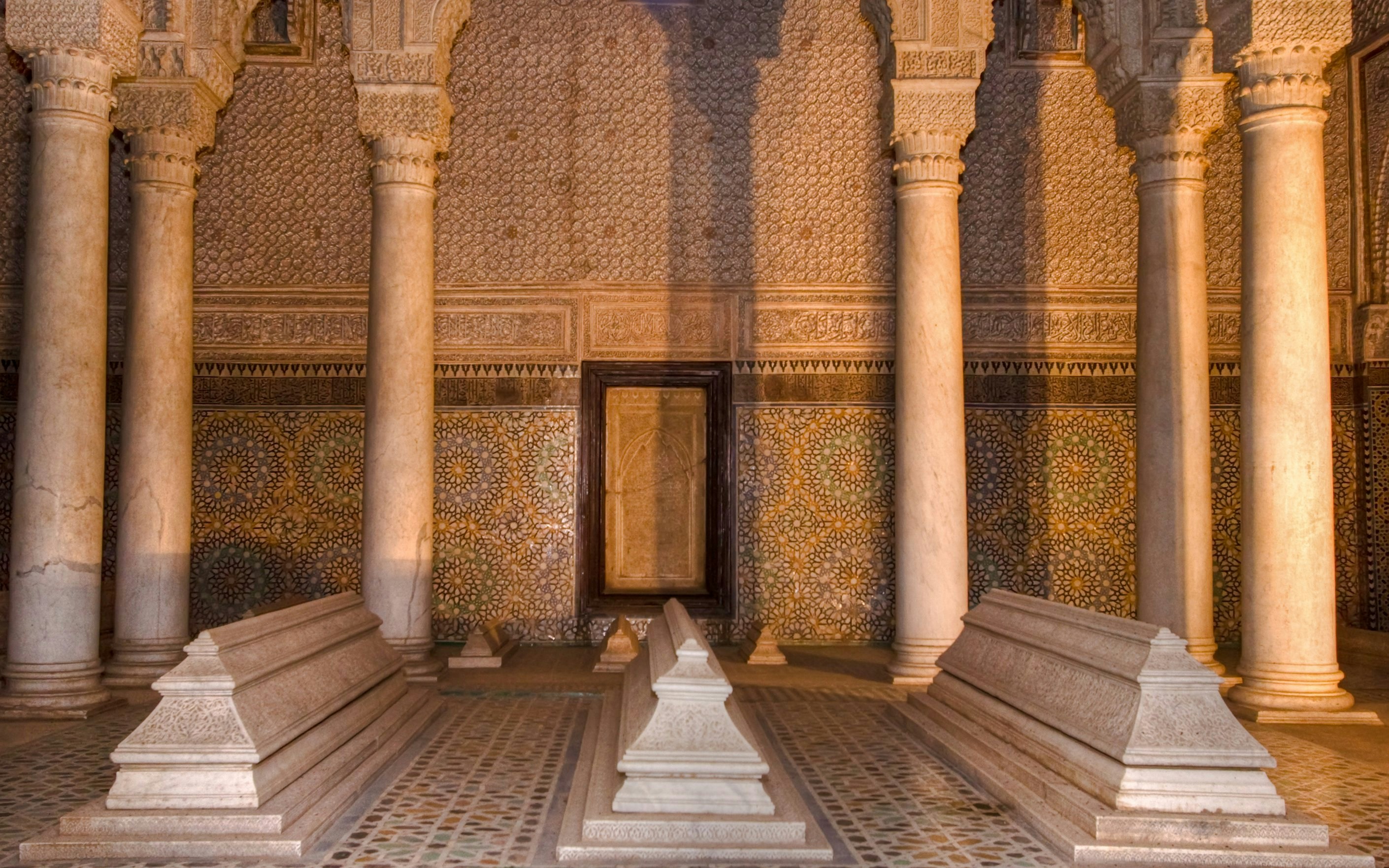 Saadian tombs with ornate columns and mosaic tiles in Marrakesh.