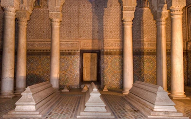 Saadian tombs with ornate columns and mosaic tiles in Marrakesh.