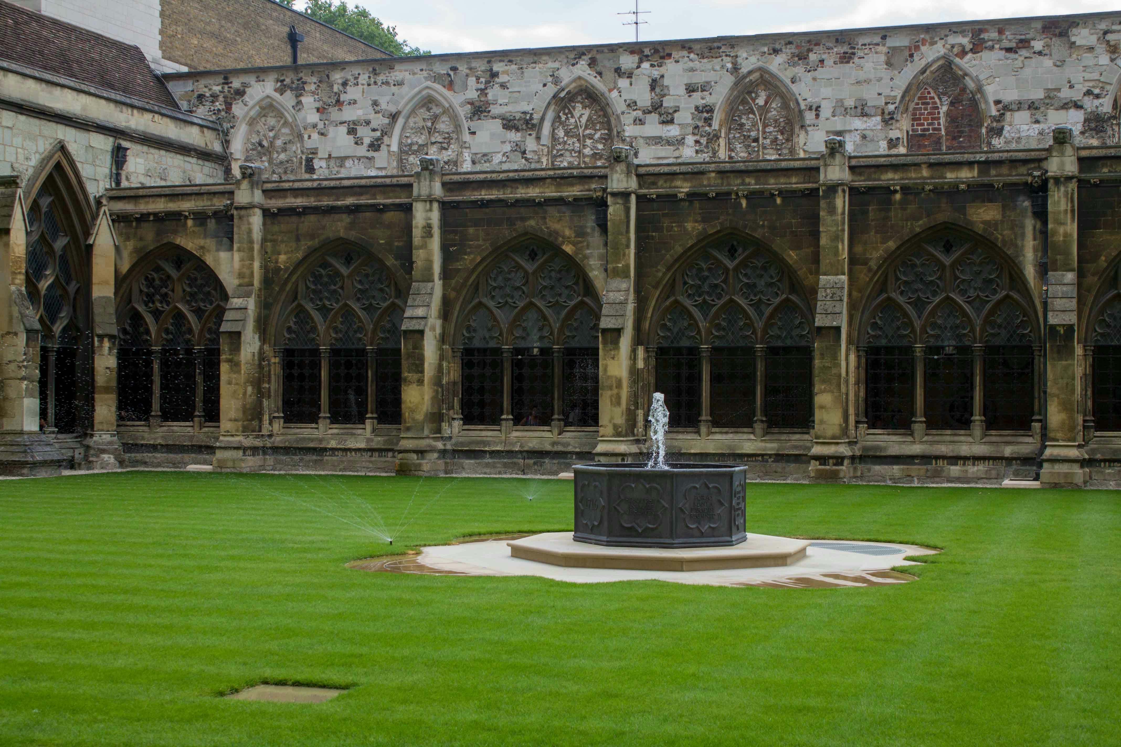 Westminster Abbey garden with fountain and Gothic arches in London.