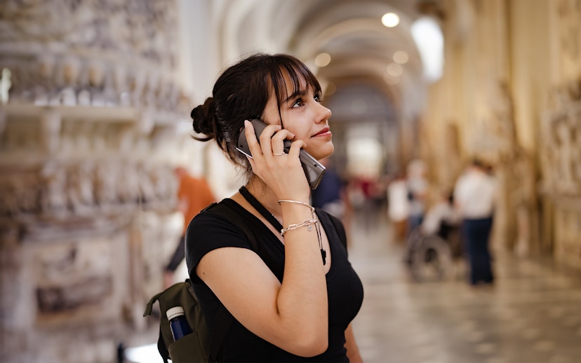 Visitor using an audio guide inside a historic building, related to Westminster Abbey and Tower of London tour.