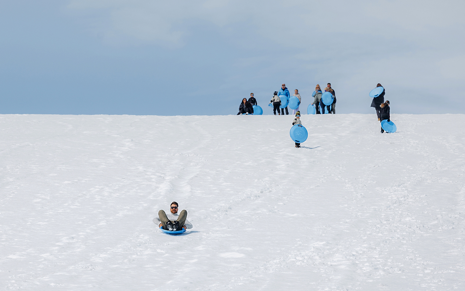 Guests sledding on Langjökull Glacier during Red Glacier Monster Truck Tour.