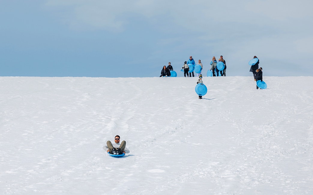 Guests sledding on Langjökull Glacier during Red Glacier Monster Truck Tour.
