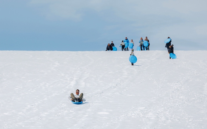 Guests sledding on Langjökull Glacier during Red Glacier Monster Truck Tour.