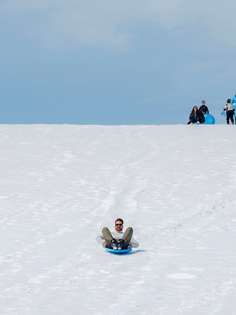 Guests sledding on Langjökull Glacier during Red Glacier Monster Truck Tour.