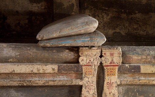 Ancient stone sarcophagus with painted details at Ipogeo dei Cristallini, Naples.