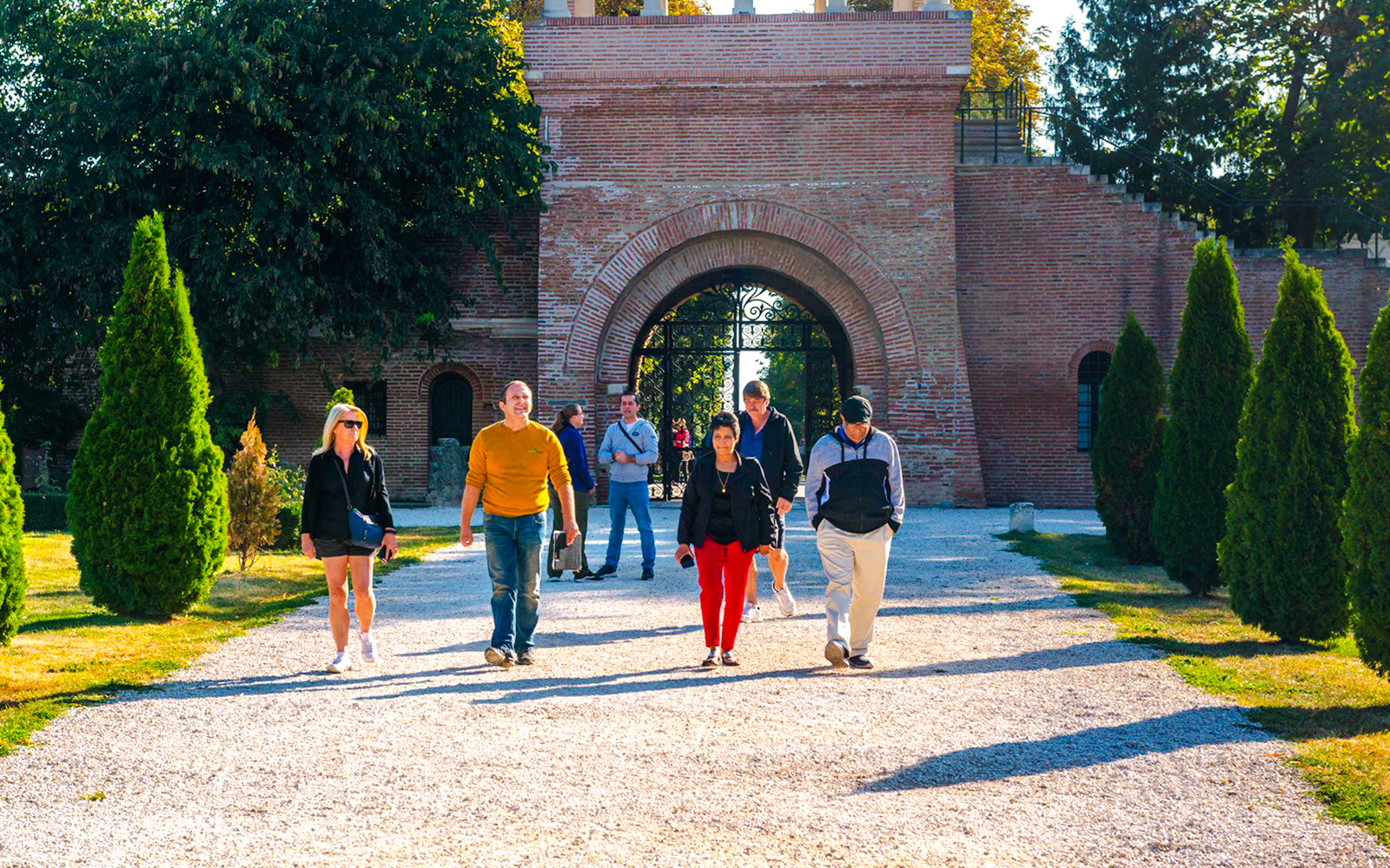 Tour group walking through Mogosoaia Palace entrance, Romania.