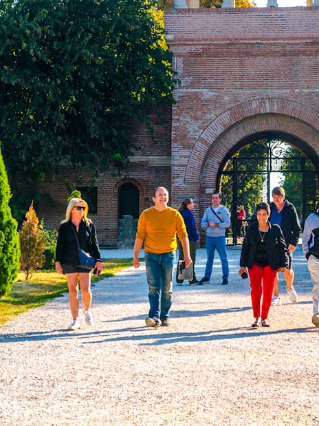Tour group walking through Mogosoaia Palace entrance, Romania.