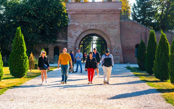 Tour group walking through Mogosoaia Palace entrance, Romania.