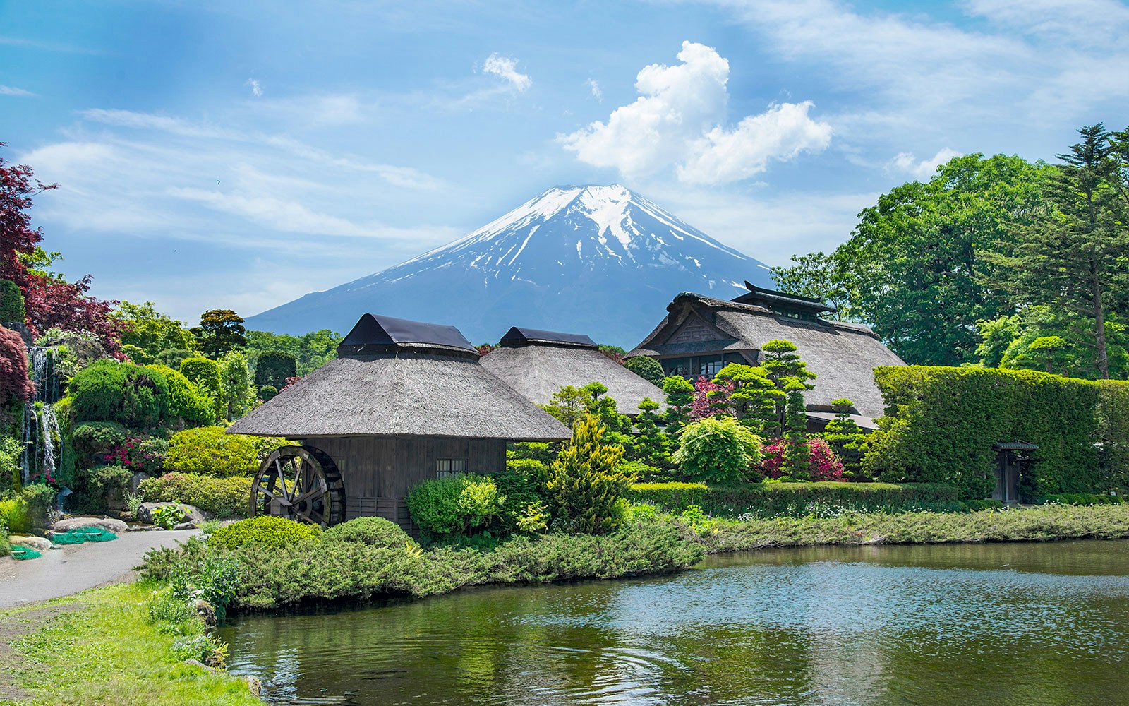 Traditional Japanese village near Oshino Hakkai's sacred ponds with Mount Fuji in the background.