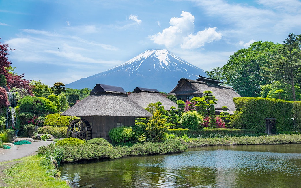 Traditional Japanese village near Oshino Hakkai's sacred ponds with Mount Fuji in the background.