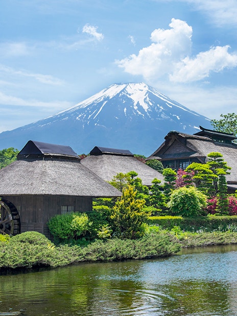 Traditional Japanese village near Oshino Hakkai's sacred ponds with Mount Fuji in the background.