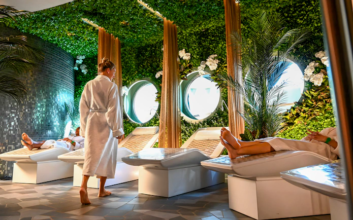 Spa area on Disney Adventure Cruise from Singapore with people relaxing on loungers.