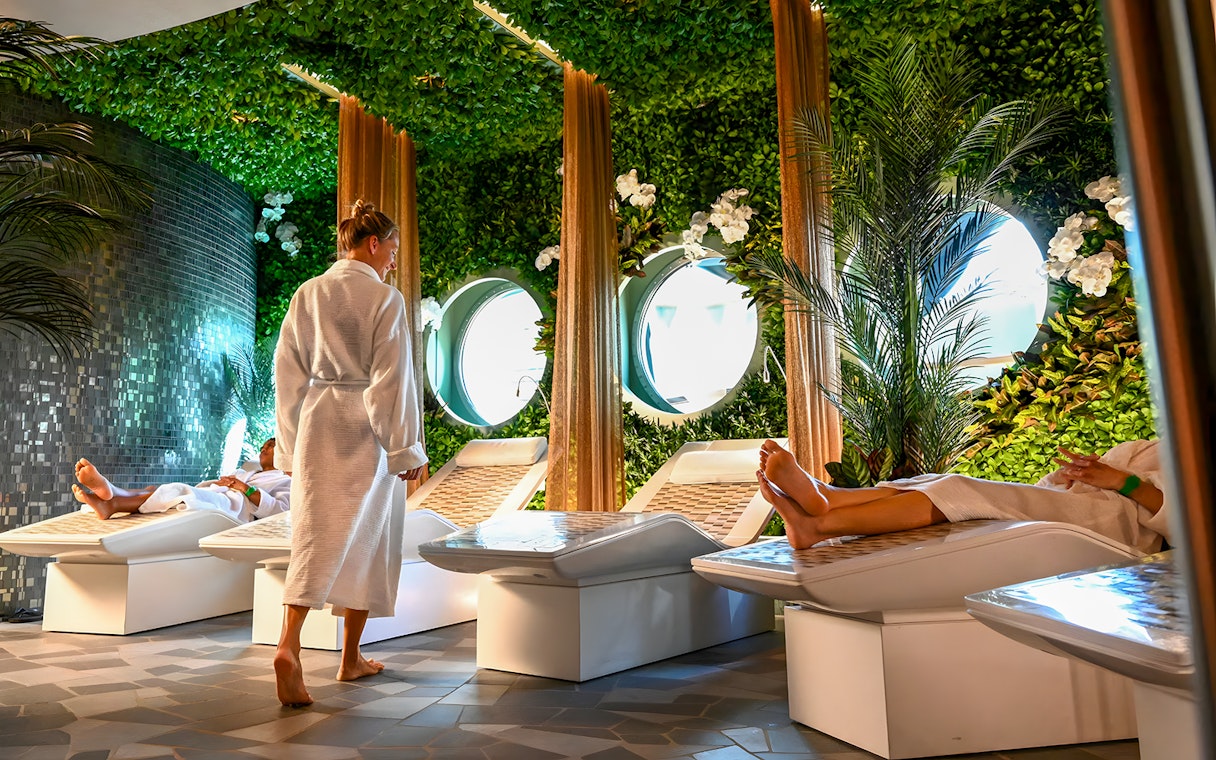 Spa area on Disney Adventure Cruise from Singapore with people relaxing on loungers.