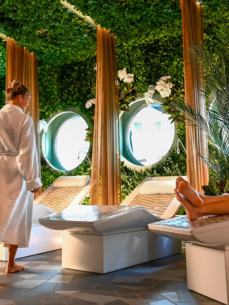 Spa area on Disney Adventure Cruise from Singapore with people relaxing on loungers.