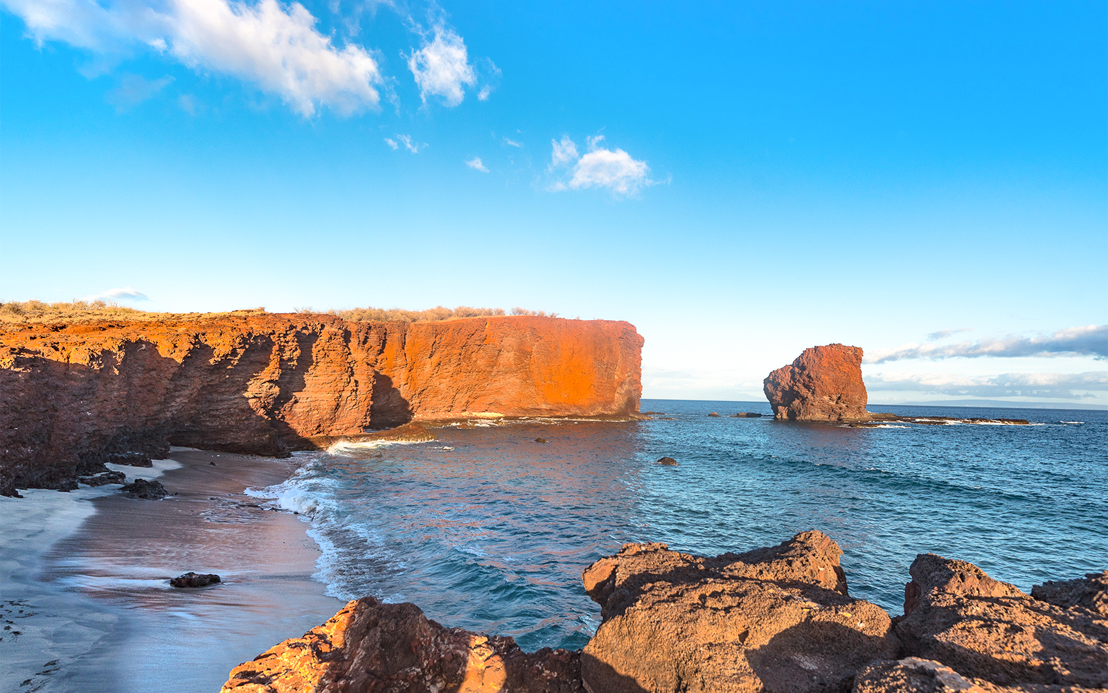 Red cliffs and ocean view at Puu Pehe, Lanaʻi, Hawaii.