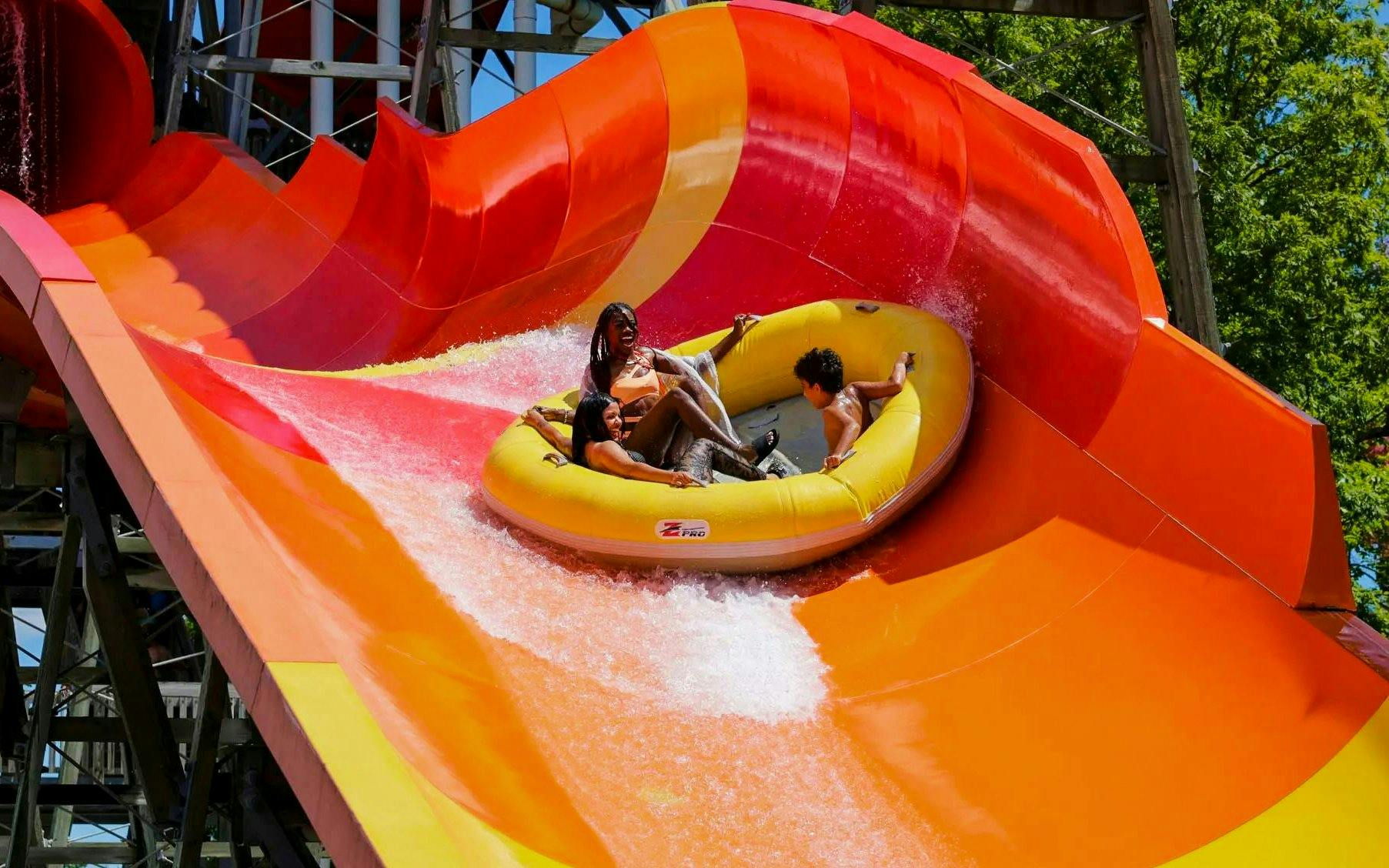 Rafting down a vibrant water slide at Hurricane Harbor Chicago.