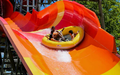 Rafting down a vibrant water slide at Hurricane Harbor Chicago.