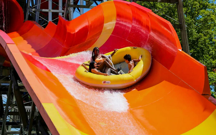 Rafting down a vibrant water slide at Hurricane Harbor Chicago.