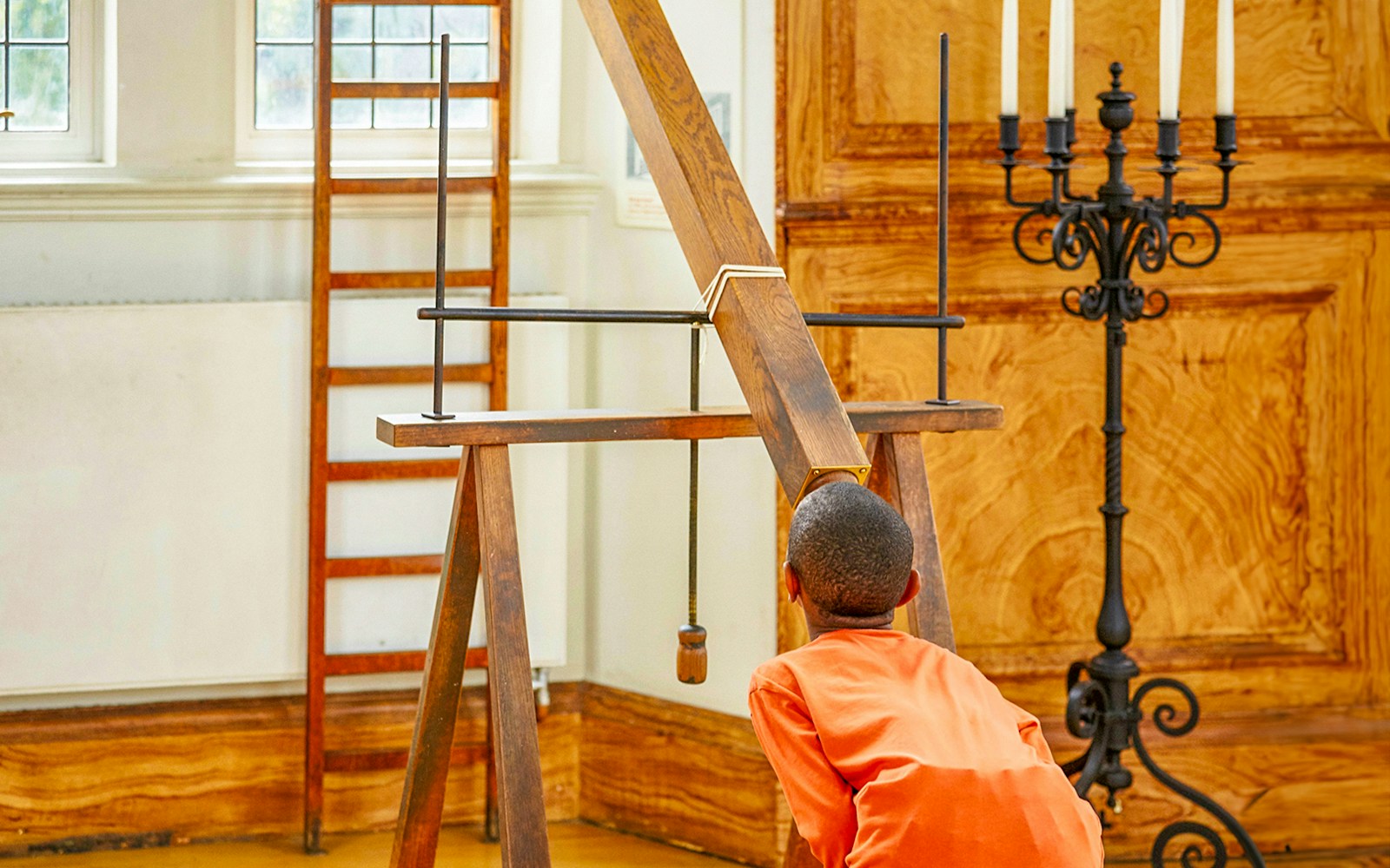 Child observing a historical telescope at Royal Observatory Greenwich.