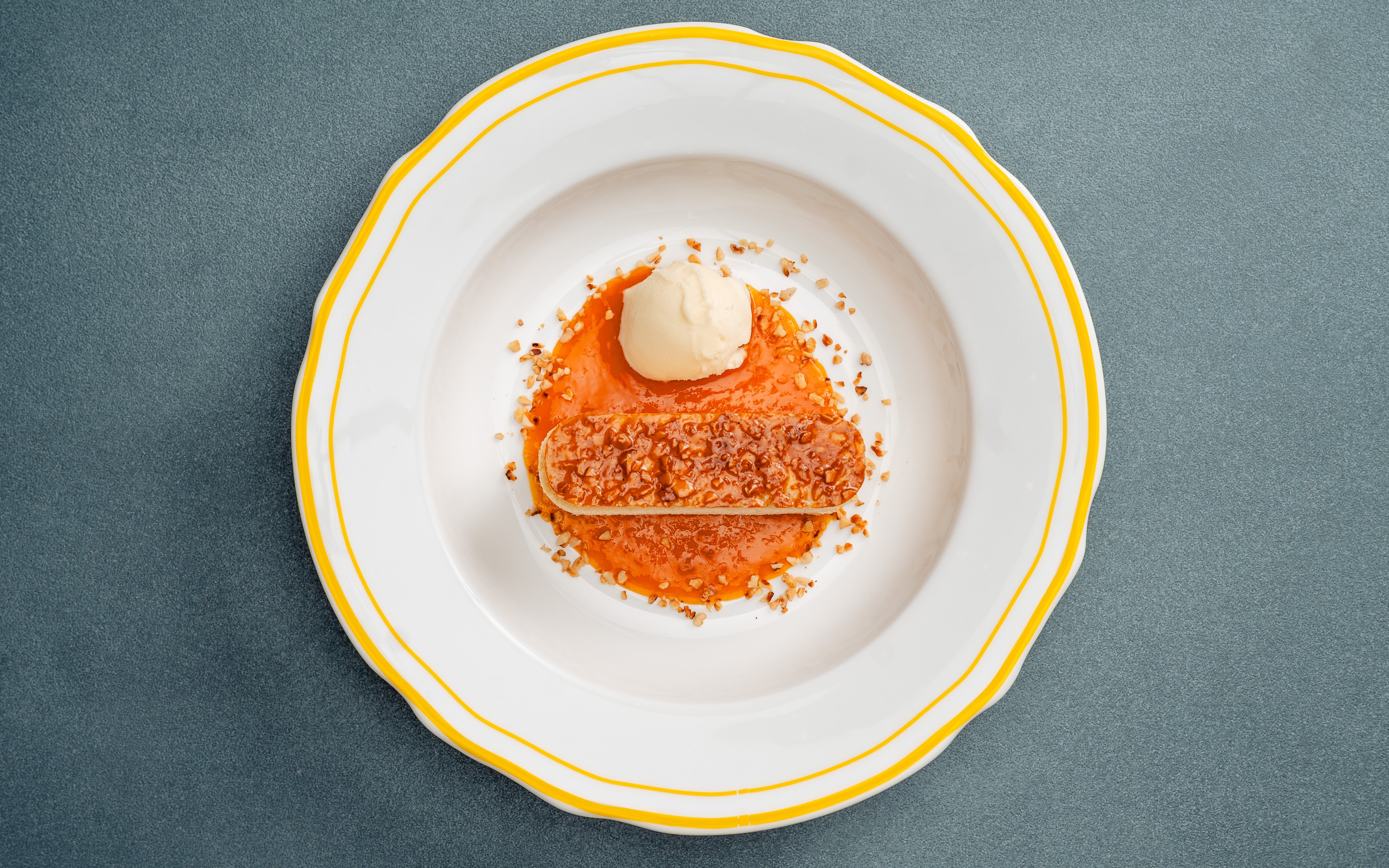 Bee Sting Cake with caramelized almond topping, served with ice cream and fruit sauce.