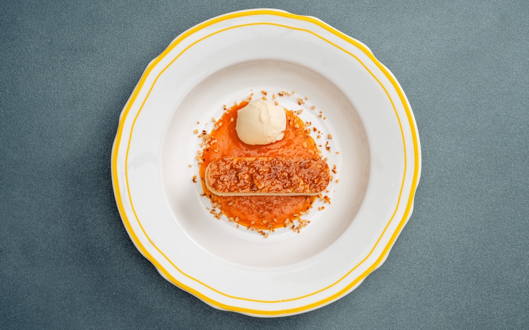 Bee Sting Cake with caramelized almond topping, served with ice cream and fruit sauce.