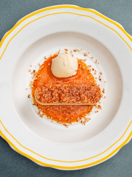 Bee Sting Cake with caramelized almond topping, served with ice cream and fruit sauce.