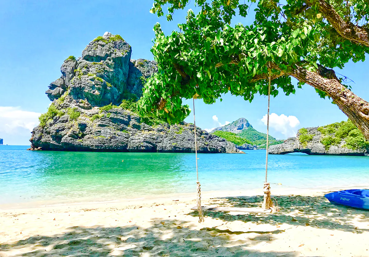 Swing on a beach with limestone cliffs in Ang Thong National Marine Park, Koh Samui.