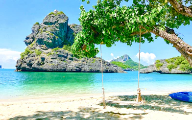 Swing on a beach with limestone cliffs in Ang Thong National Marine Park, Koh Samui.