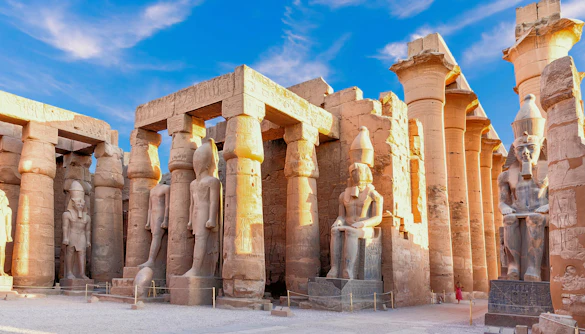 Statues and columns in the Great Court of Ramesses II at Luxor Temple, Luxor, Egypt.