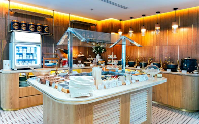 Buffet spread at Coral Airport Lounge, Suvarnabhumi Airport, featuring snacks and beverages.