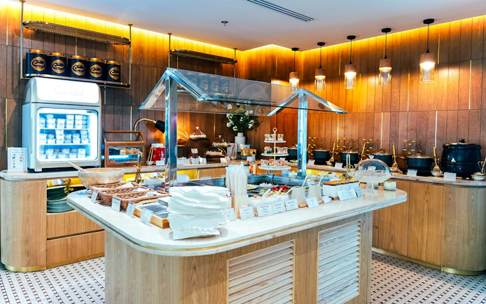 Buffet spread at Coral Airport Lounge, Suvarnabhumi Airport, featuring snacks and beverages.