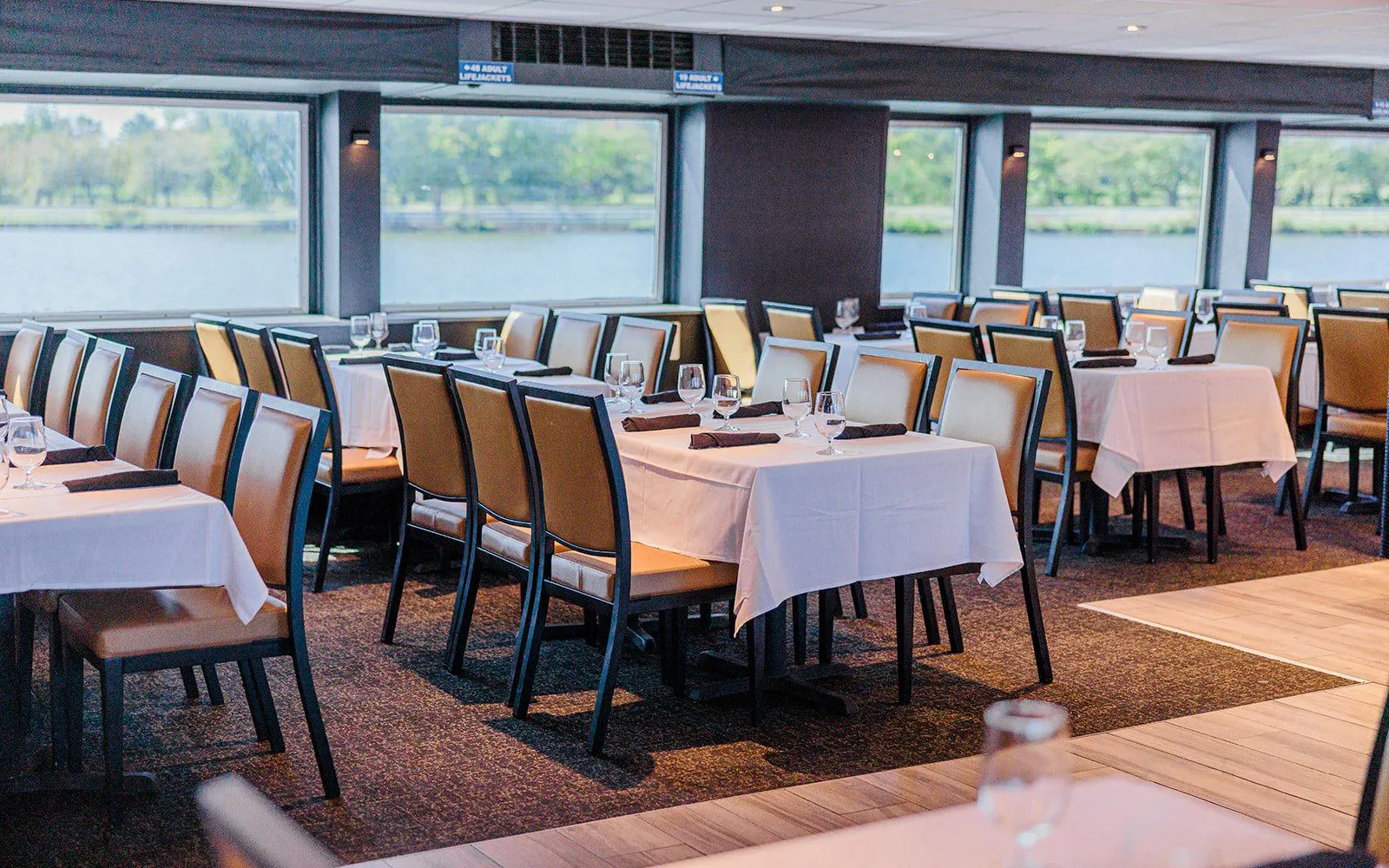 Dining area set for brunch on the Signature Bottomless Mimosa Cruise, Washington DC.