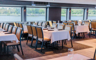Dining area set for brunch on the Signature Bottomless Mimosa Cruise, Washington DC.