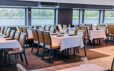 Dining area set for brunch on the Signature Bottomless Mimosa Cruise, Washington DC.